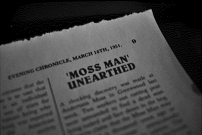 Detail of the newspaper clipping reading Moss Man Unearthed