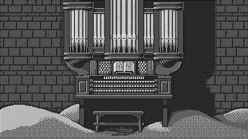 Organ on a stone room with the floor covered with sand