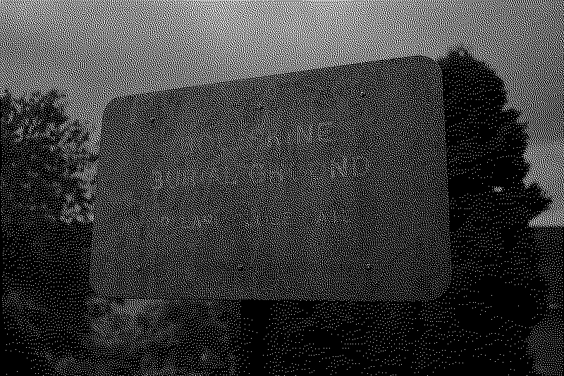 A faded sign marks the entrance of the cemetery