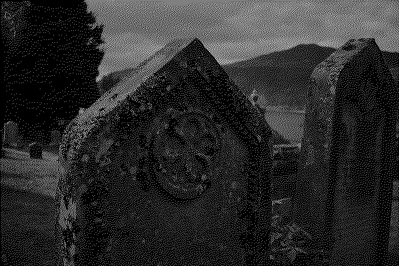 Moss covered gravestones with the Loch Ness in the distance