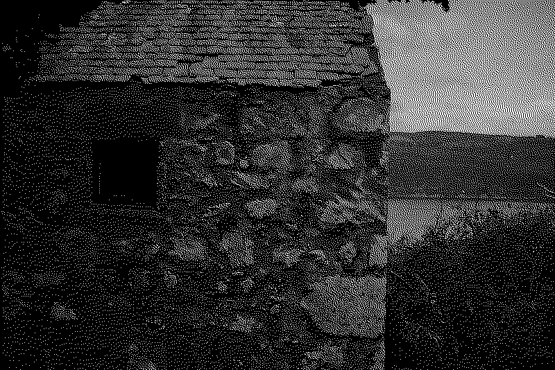 A strange boarded up stone house lies in a corner