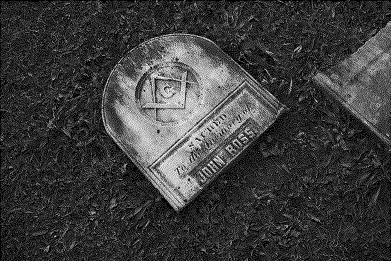 A broken gravestone with a masonic symbol