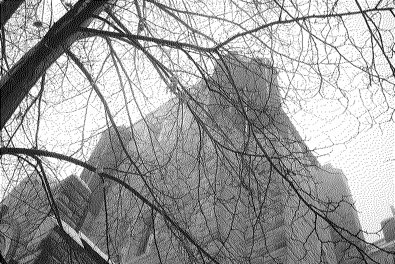 A stout stone steeple with a layer of branches, fading in the fog