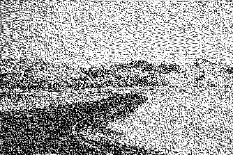 Winding road through a snowy and mountainous landscape