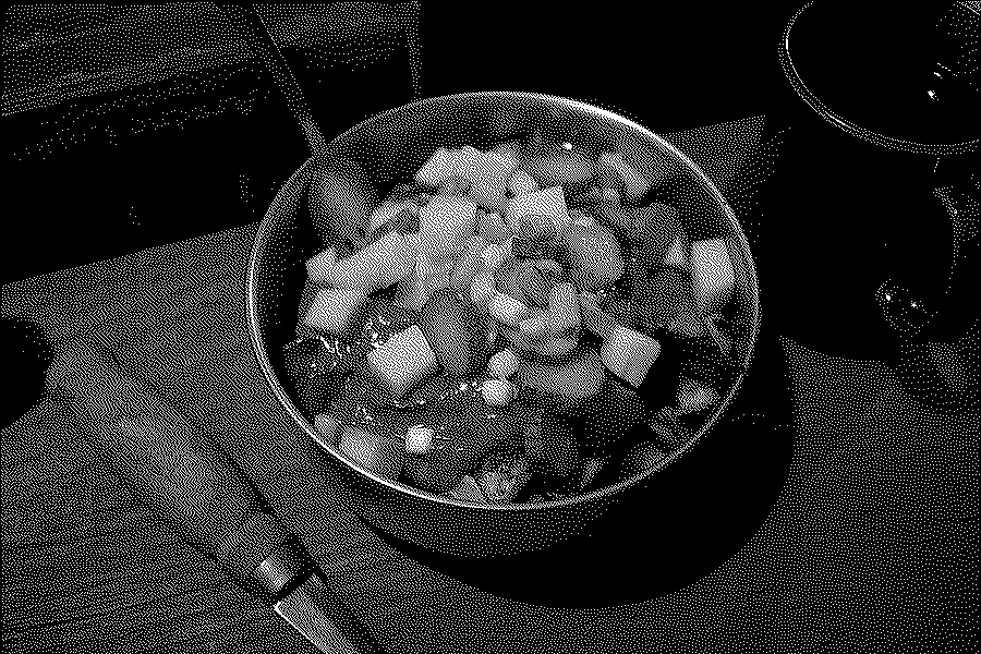 Plant-based poutine with pickles in a metal bowl