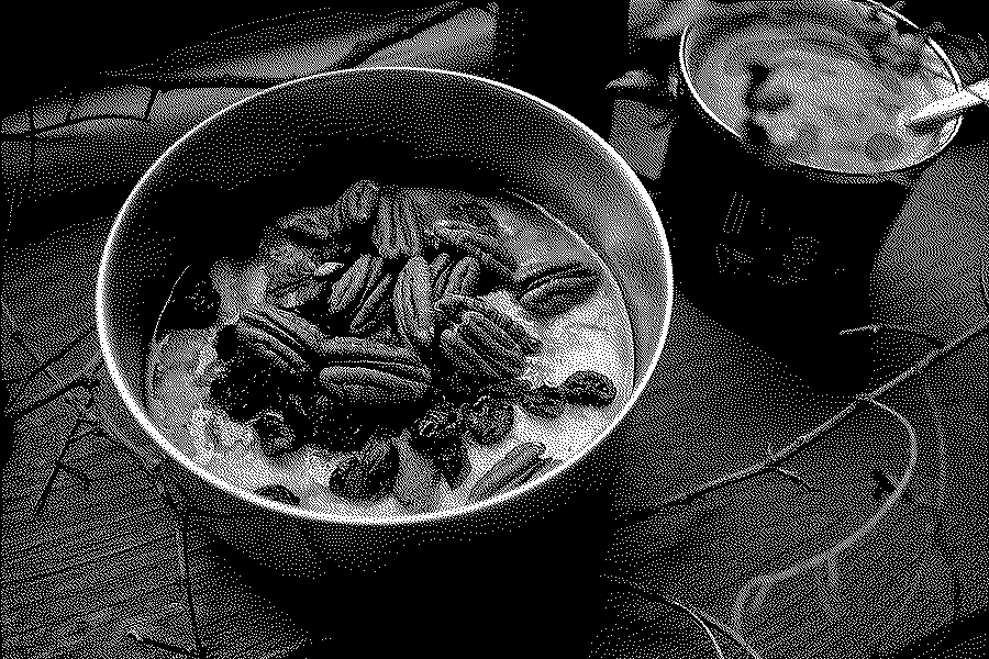 Steel-cut oats with cranberries, nuts and spices in a metal bowl