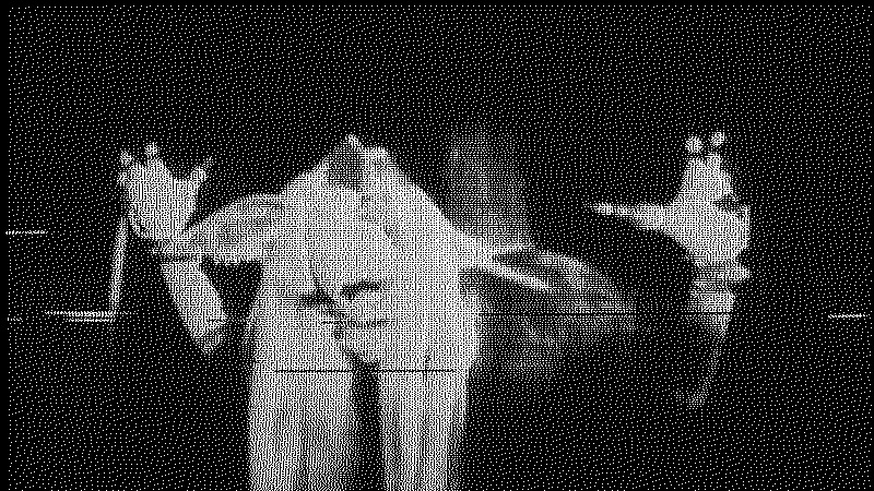 Shot of the beast with their arms raised processed through a crt and an analog glitcher
